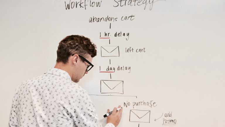 man drawing email automation series on a board