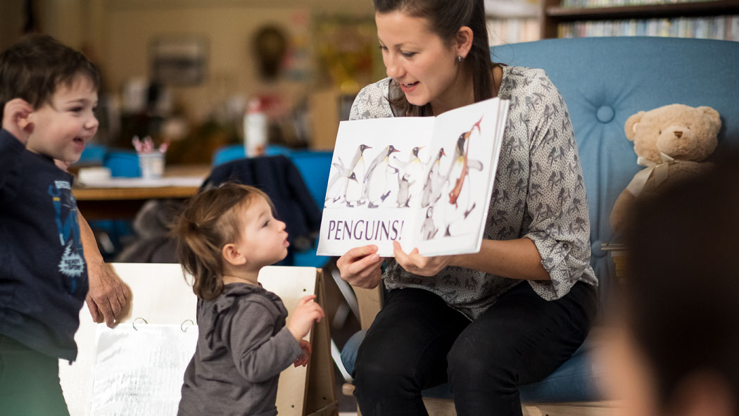 woman reading to children in a library