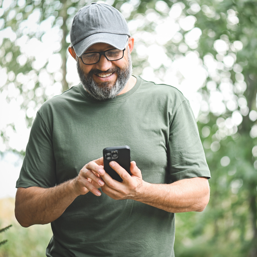 Man walking in the park with a mobile phone